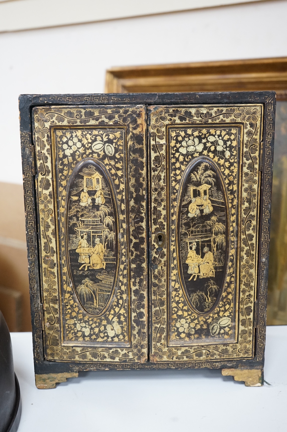 A mid 19th century Chinese export gilt-decorated lacquer two door cabinet, with five drawers, 38cm